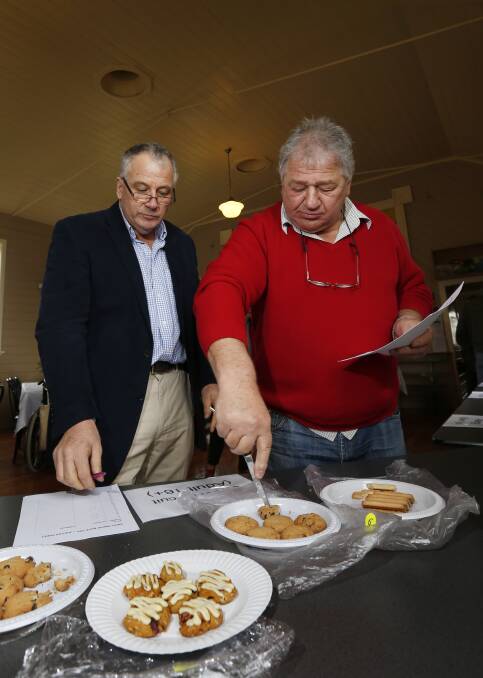 BAKERS DELIGHT: Moyne mayor Colin Ryan and Cr Jim Doukas put their tastebuds to the test to judge entries in The Kirky Bikkie Bake-off. Picture: Aaron Sawall