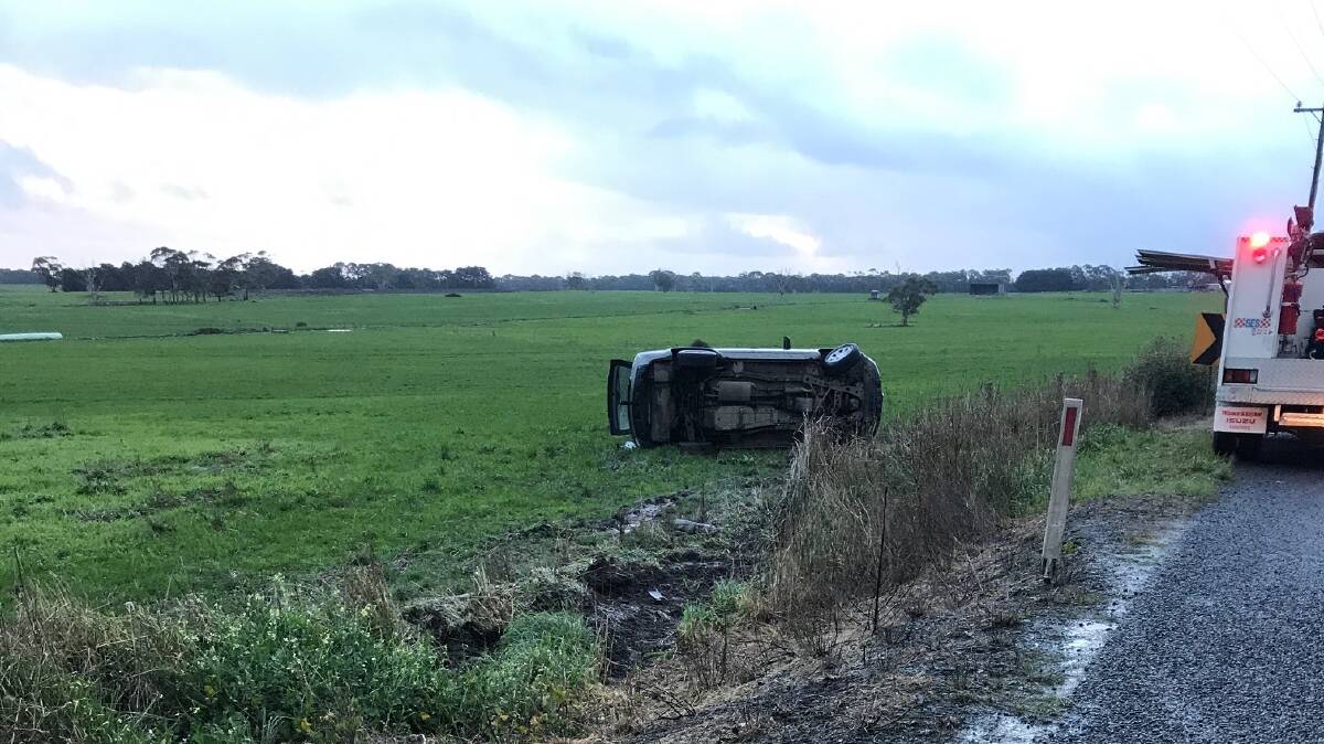 A car landed on its side in a paddock on the Cobden-Warrnambool Road on Sunday. No one was injured.