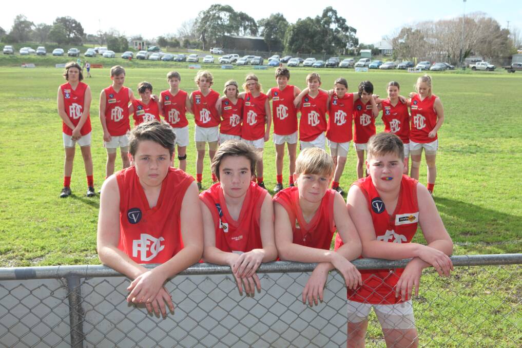 Not impressed: Dennington under 14s including Harry Moss, 14, Caleb Arthur, 13, Ben Mulcahy, 13 and Zac Jenkins, 13, had to scrape together old footy guernseys in time for Saturday's game at Panmure after thieves stole their trailer full of gear.