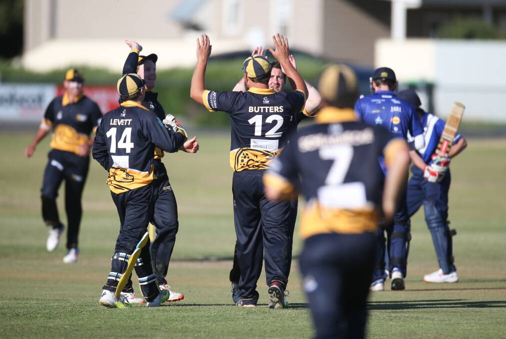 PROUD MOMENT:
Woodford captain Nick
Butters high fives Luke
Wines after the fall of a 
wicket. Picture: Amy Paton