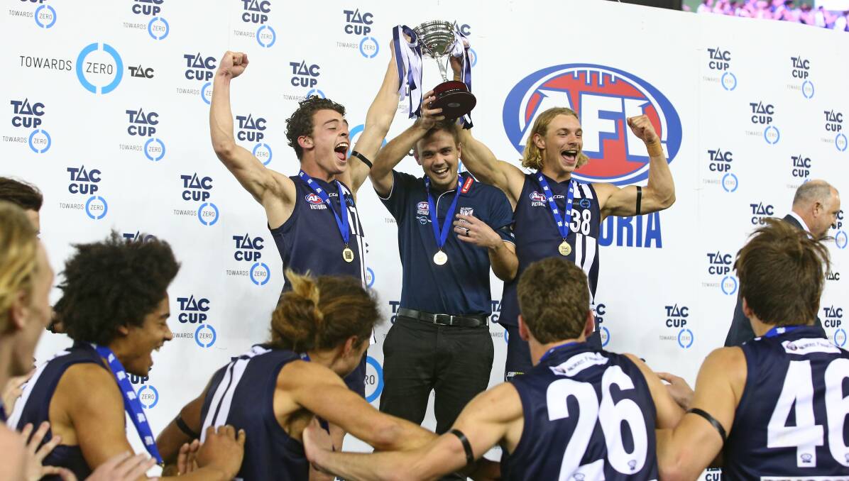 JOY: Danny O'Keefe (centre) guided Geelong Falcons to their first TAC Cup premiership in more than 17 years on Sunday. Picture: AFL Victoria