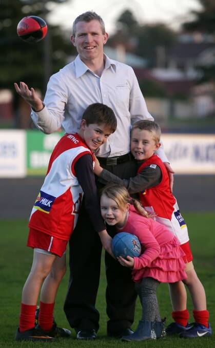 BACK IN THE SADDLE: Jacob Rhodes, pictured with his children on the eve of his 150th game for South Warrnambool, will coach Dennington in 2017. Picture: Damian White
