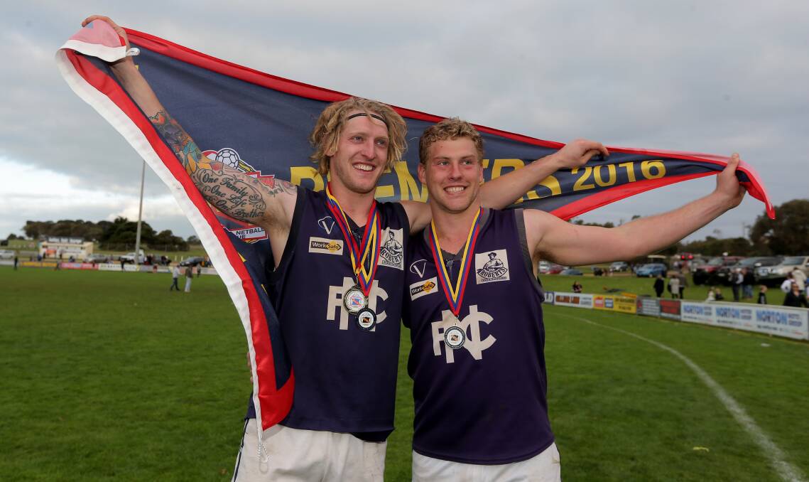 WE DID IT: Nathan Couch (right) with his brother Mitch and the premiership flag after the win. Picture: Rob Gunstone.