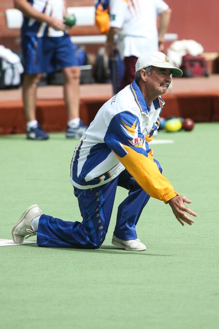 TECHNIQUE: Warrnambool Blue player Langy Johnson gets down on one knee as he watches his bowl heads towards the jack. Picture: Amy Paton