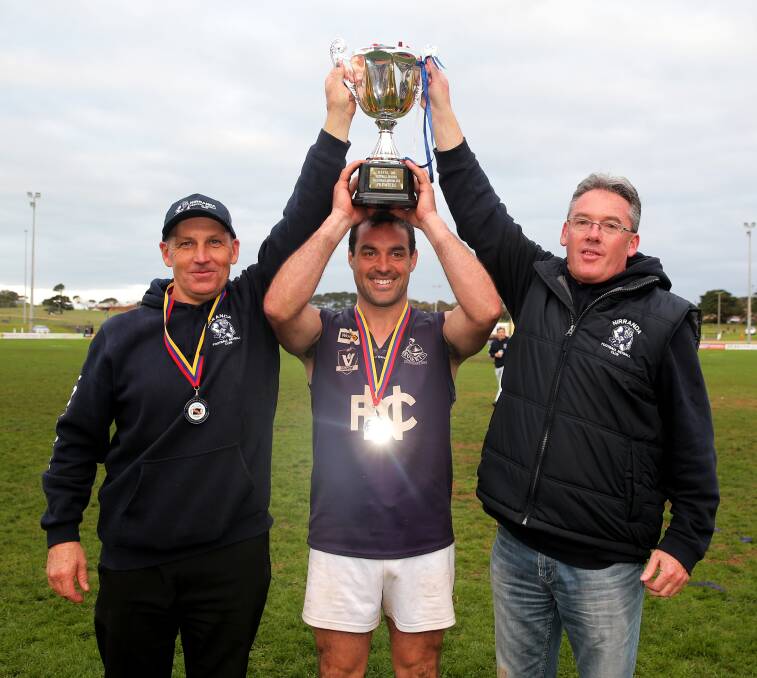 TRIUMPHANT: Co-coach Shane Quick, captain Peter McDowall and co-coach Shane Threlfall with the premiership cup. Pictures: Rob Gunstone