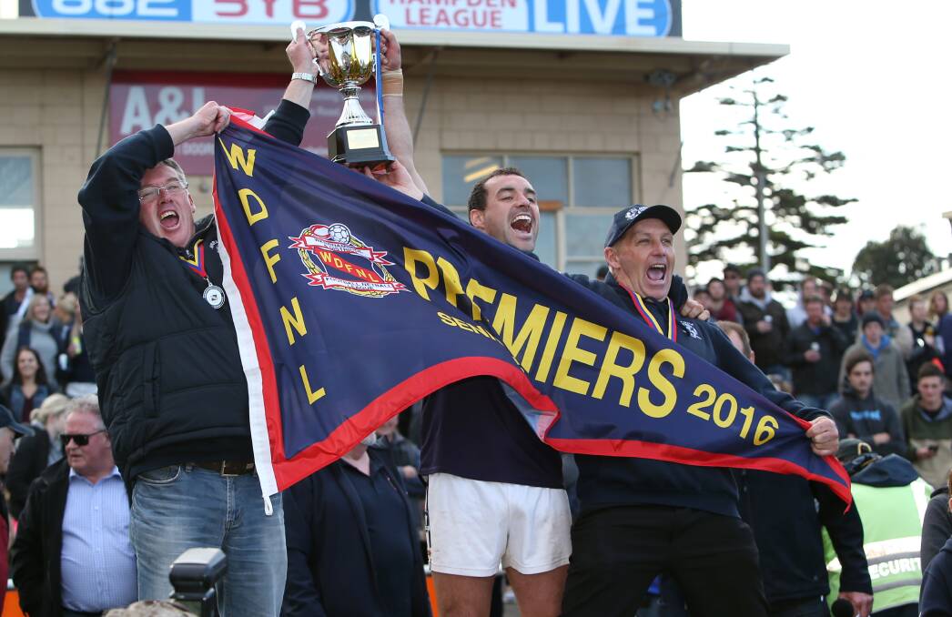 PREMIERS: Shane Threlfall (left) lifts the premeirship cup with Peter McDowall (middle) and Shane Quick (right). Picture: Amy Paton