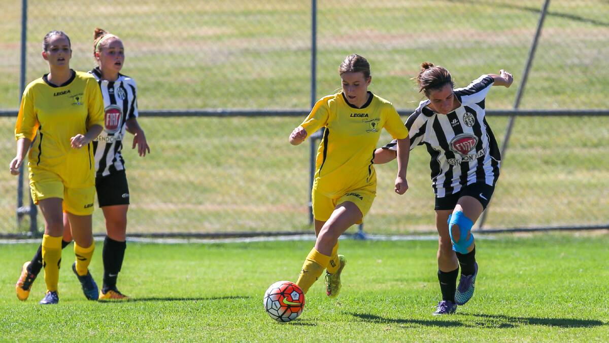 JOSTLING: Ashley Butler keeps ahead of her Moreland Zebras opponent in a Team APP Cup match on Sunday. Wolves lost comprehensively but fought hard. Picture: Rob Gunstone