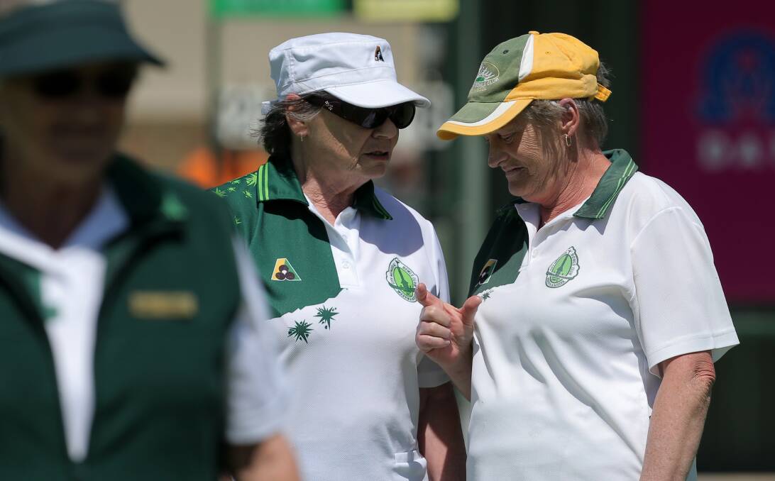 THIS CLOSE: City Memorial bowlers Margaret Hoy and Kaye Maddern discuss tactics in their three-shot win over Warrnambool Gold on Tuesday. Picture: Rob Gunstone