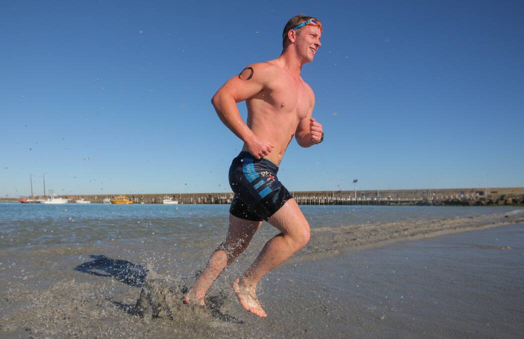 FUN IN THE SUN: Harvey Browne emerges out of the water during the Warrnambool Tri Club Aquathon, held at the Warrnambool breakwater. Picture: Morgan Hancock