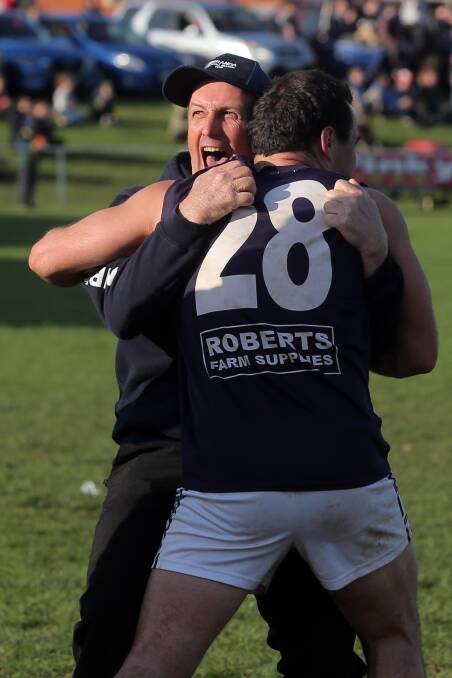 PASSION: Nirranda co-coach Shane Quick excitedly embraces Blues captain Peter McDowall after the siren in last season's grand final. Picture: Rob Gunstone