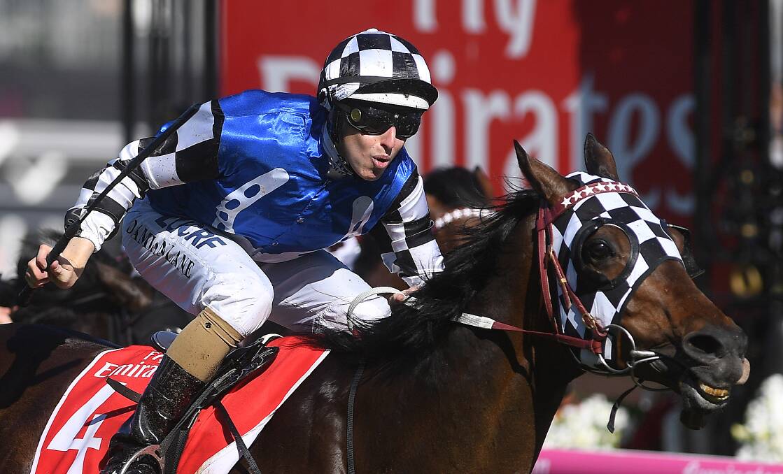 BIG EFFORT: Damian Lane riding Tosen Stardom to victory in the Emirates Stakes on Stakes Day at Flemington Racecourse. Picture: AAP/Julian Smith