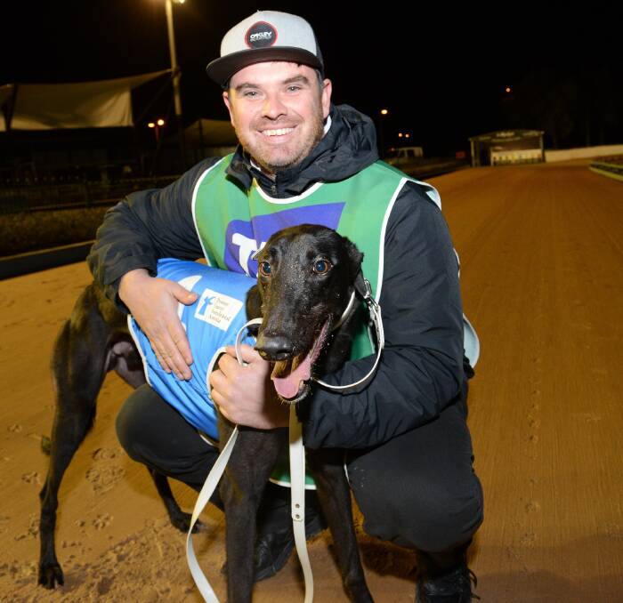 MAKING HISTORY: Ray Drew's son and fellow Warrnambool greyhound trainer Dustin Drew with Kilty Express after the greyhound's semi-final placing. PICTURE: Clint Anderson
