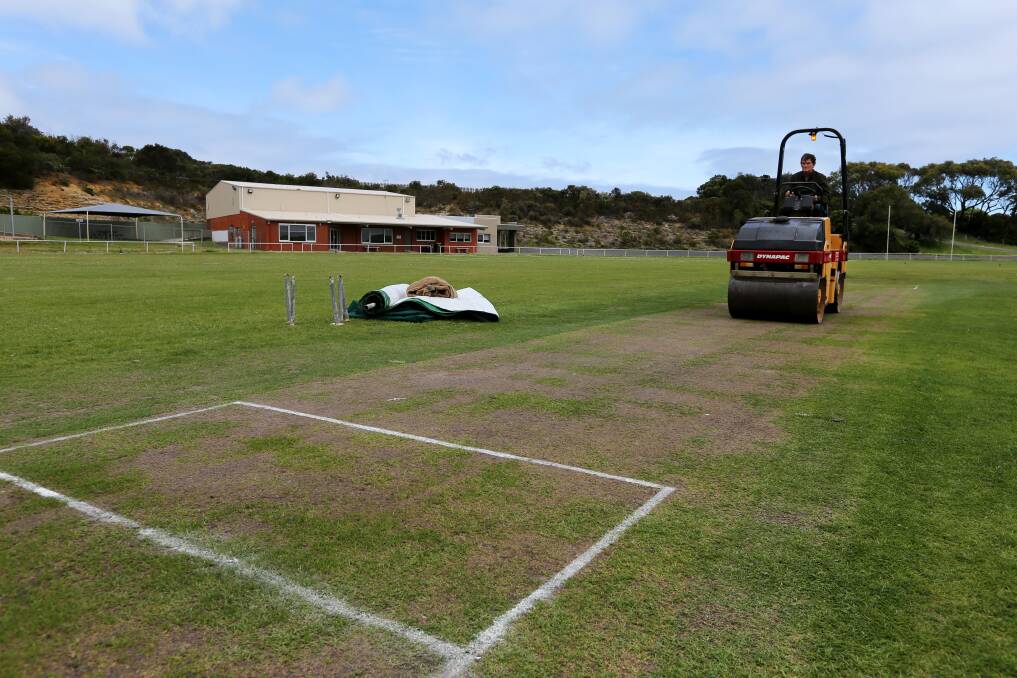 NEW ERA: Nirranda Cricket Club volunteer Tony Sudale runs the heavy roller over the club's new turf cricket pitch on the Port Campbell Recreation Reserve. Picture: Rob Gunstone