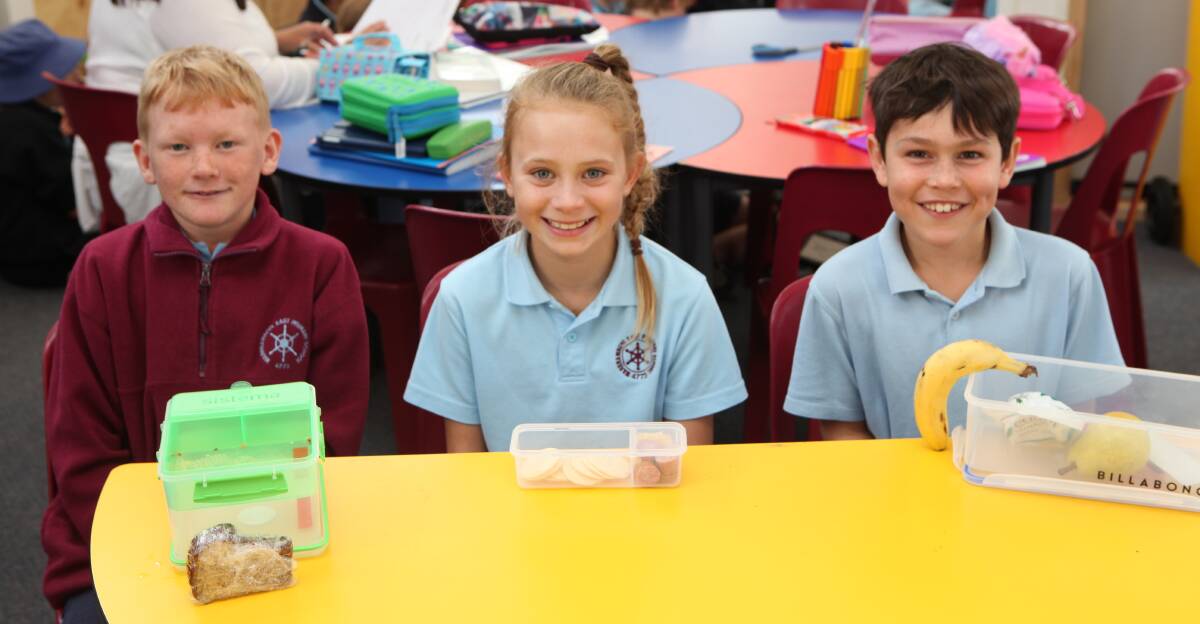 Mellow yellow: Warrnambool East Primary School Year 6 students Ethan Klein, 10, Alice Cann, 10 and Zane Jones, 10, regularly enjoy a quiet reading in the classroom at 11.35am before their early lunch break. Picture: Rebecca Riddle.