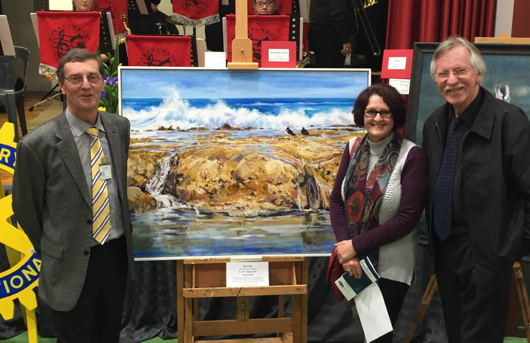 A STANDOUT: City of Warrnambool Art Show winner Susan Sambell of Warrnambool with her winning painting, Rotarian Roger Cussen (left) and judge Ross Paterson.
