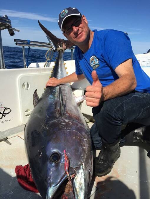 Hook, line and sinker: Port Fairy fisherman and Salty Dog charter operator Daniel Hoey says he is living his life by the motto: "Nothing ventured, nothing gained." Pictured here with bluefin tuna.