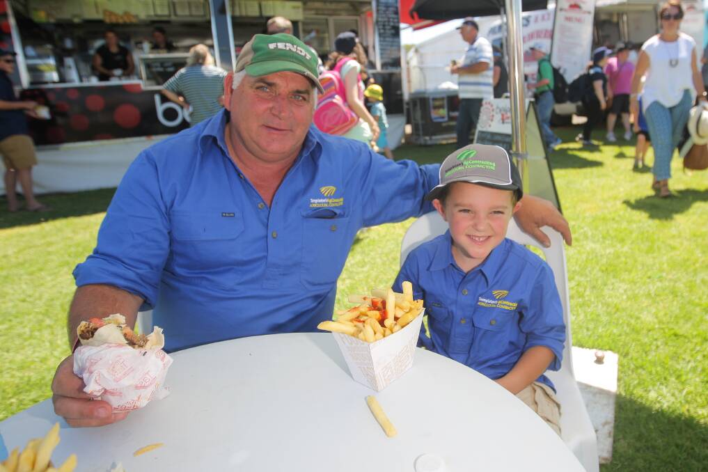 Farm hand: Ian Templeton and grandson, Jackson Goldstraw, 6  of Glenormiston, take a well-earned break from sales to enjoy lunch on the green.