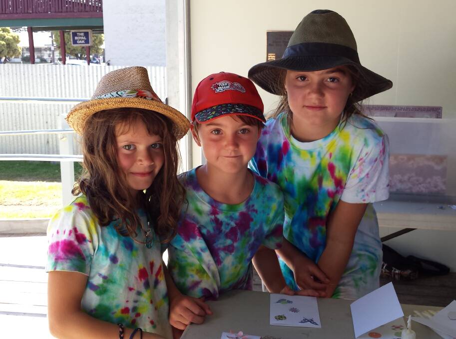 Craft: Hannah Dowsett, 7, with siblings Darcy Venn, 6, and Matilda Venn, 11, from Pomonal enjoy a free card making session as part of Port Fairy's Moyneyana Festival. 
