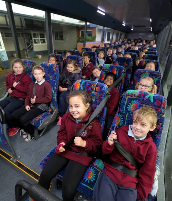 Buckle up: Grade one and two students from Warrnambool East Primary School are practising good safety on the bus following their session with BusVic on Wednesday. Picture: Rob Gunstone