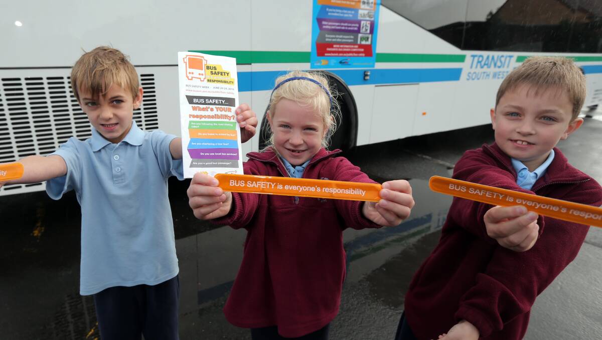 Bus fun: Harry Lucas, 7, Amelia Tuck, 6 and Josh Nesbitt, 8 make the most of Bus Safety Week sessions at Warrnambool East Primary School. Picture: Rob Gunstone.