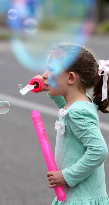 Sunshine and bubbles: Colac's Taylah Williamson, 5, was immersing herself in giant bubbles with a mixture she bought at one of the festival's stalls. Picture: Amy Paton