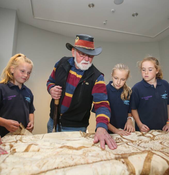 Lessons learned: Merrivale Primary School students Zahli Kelson, 12, Ava Madden, 11 and Maggie Bath, 12, are learning timeless lessons from Indigenous Elder Robbie Lowe at theWarrnambool Art Gallery.  Picture: Morgan Hancock