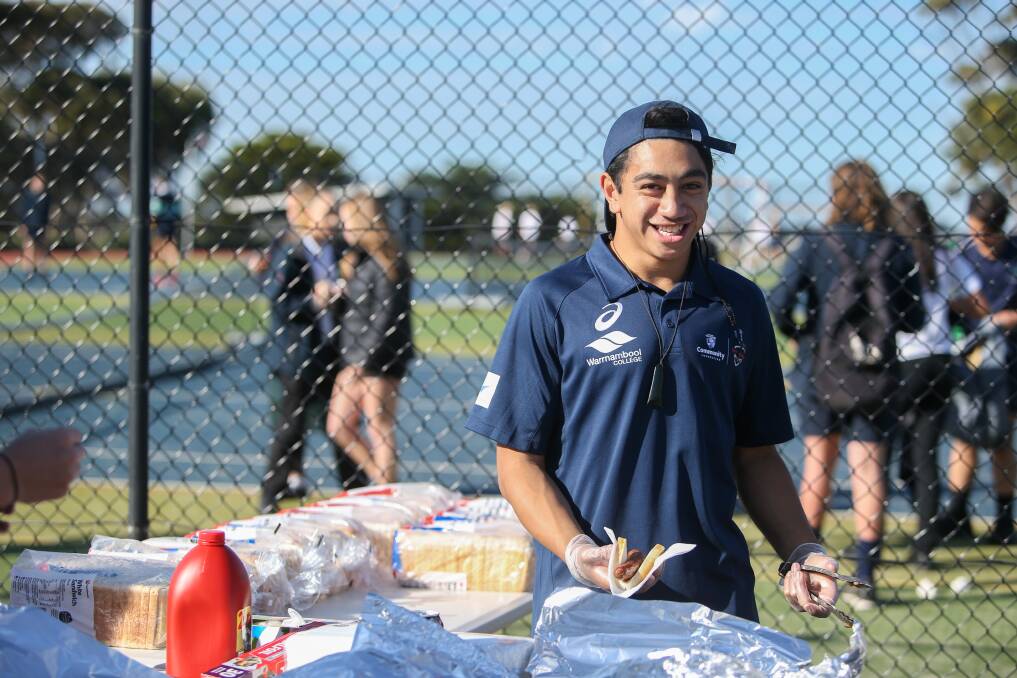 Leader: Warrnambool College student Trinity Pompey, 16, was serving sausages at the school's community event on Monday. Picture: Amy Paton.