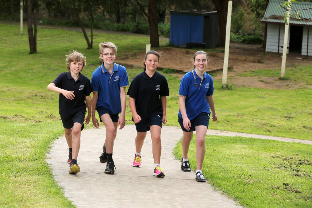 Picking up the pace: Woodford Primary School students Billy Watt, 11, Riley Thomas, 12, Nikiha Thomas, 11 and Millie Lee, 12 want to win top prize in this year's Walk to School month competition. Picture: Rob Gunstone