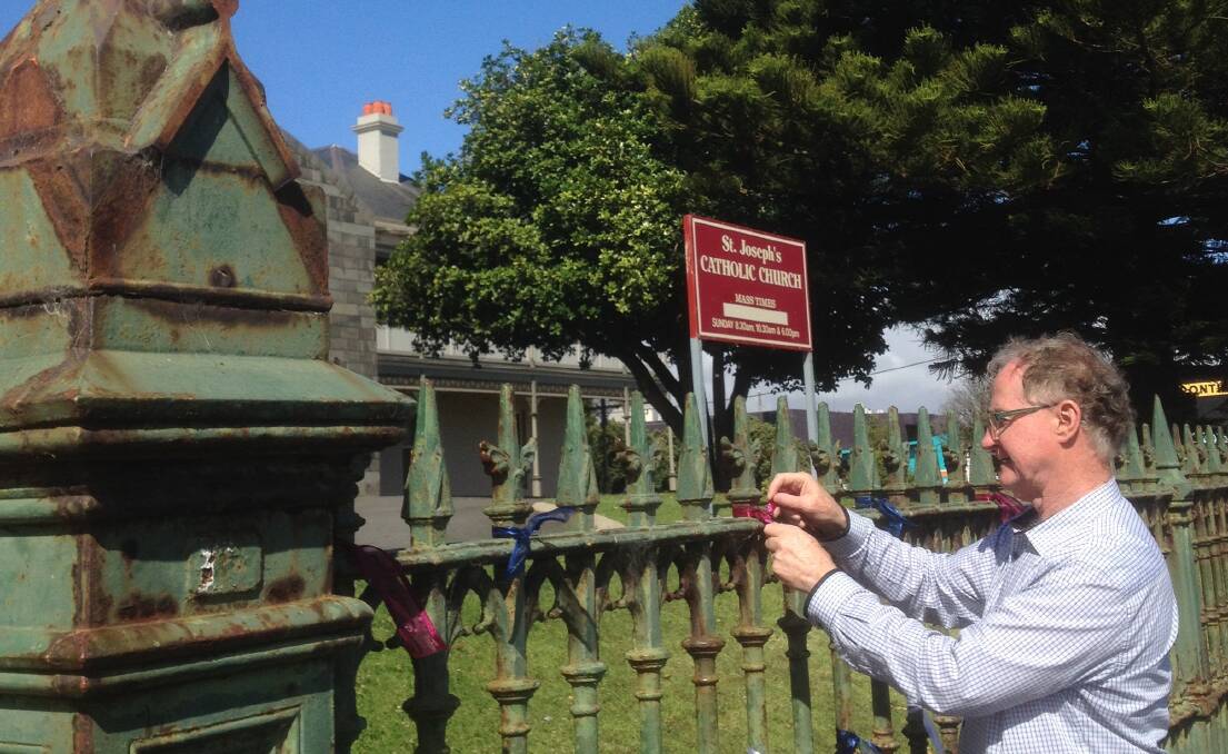 Support: Ballarat abuse survivor Peter Blenkiron tied ribbons at the front of St Joseph's Church in Warrnambool, kick-starting the Loud Fence campaign.
