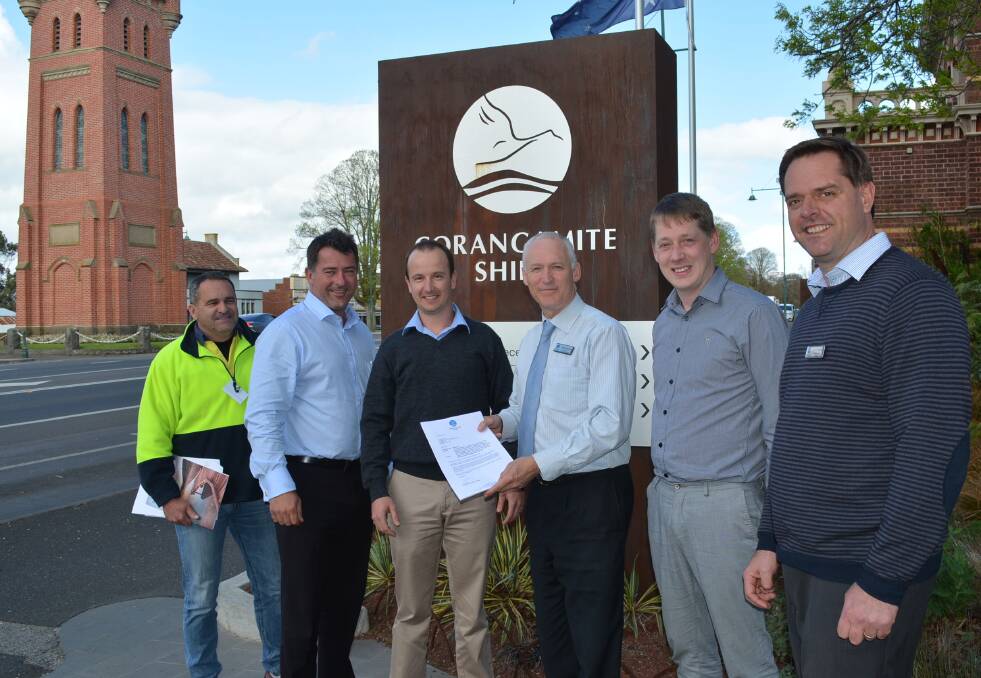 Camperdown Dairy International corporate systems manager David Mullins (left), CEO Phil McFarlane and project manager Adam Green, with Corangamite Shire’s planning building services manager Greg Hayes, planning officer Andrew Lancashire and CEO Andrew Mason at the presentation of the planning permit for the new dairy venture in October 2014.   