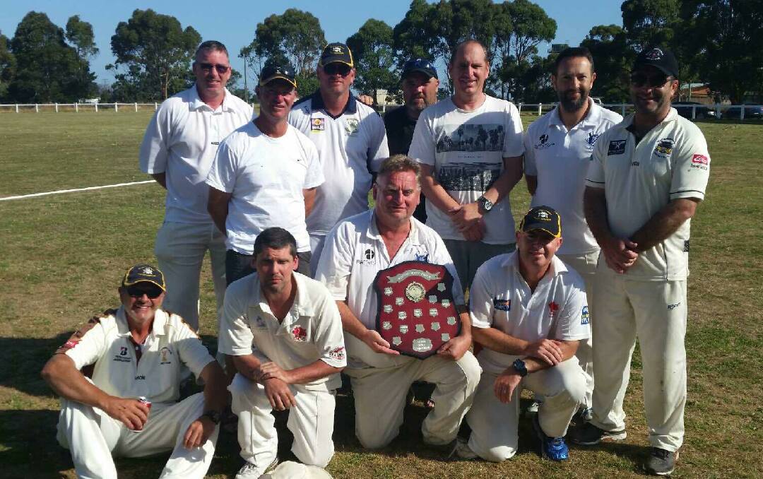 WINNERS: The Warrnambool District Cricket Association over-40s side gather for a photo with the country week shield. 