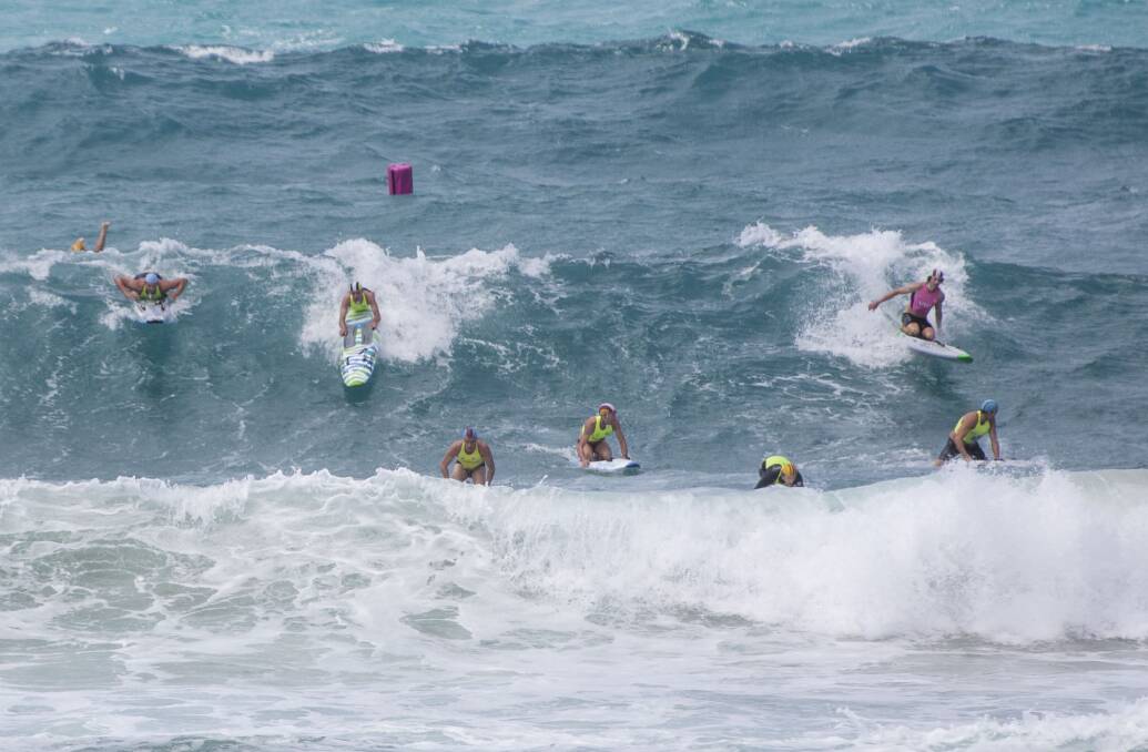 ALL ABOARD: Competitors in the men's board race prepare to catch a wave at Fairhaven, where large surf provided tricky conditions. 