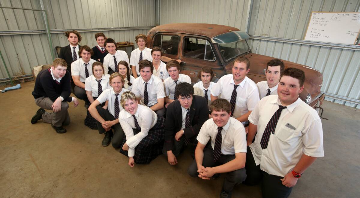 Transformation: Emmanuel College VCAL students with the car they're revamping for the school's Grease production. Picture: Amy Paton