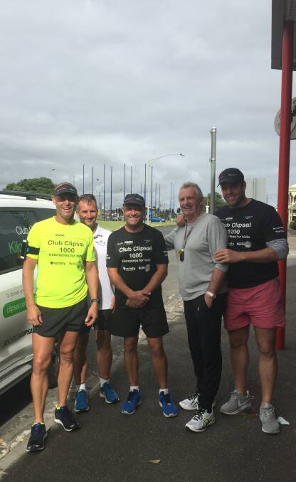 Running for good: Ashley Ralph, left, with his support team during a stop in Warrnambool on Friday. Mr Ralph is running from Melbourne to Adelaide in 10 days.
