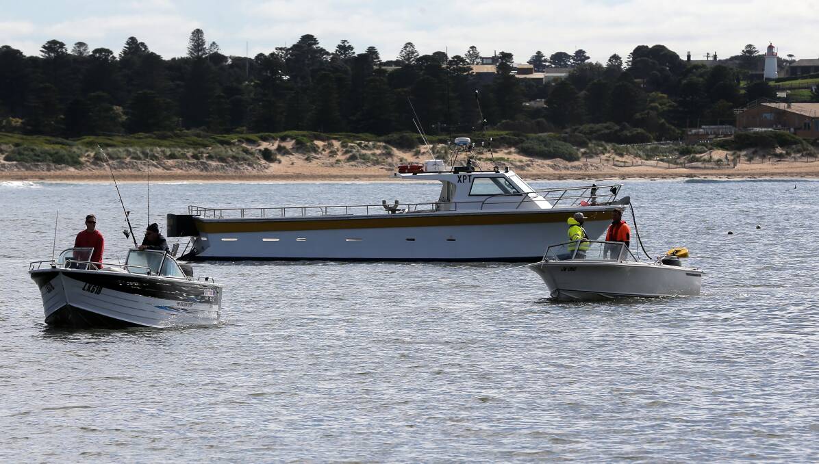 Helping hand: Two fishermen are towed back to the Warrnambool boat ramp after experiencing engine trouble. Picture: Rob Gunstone