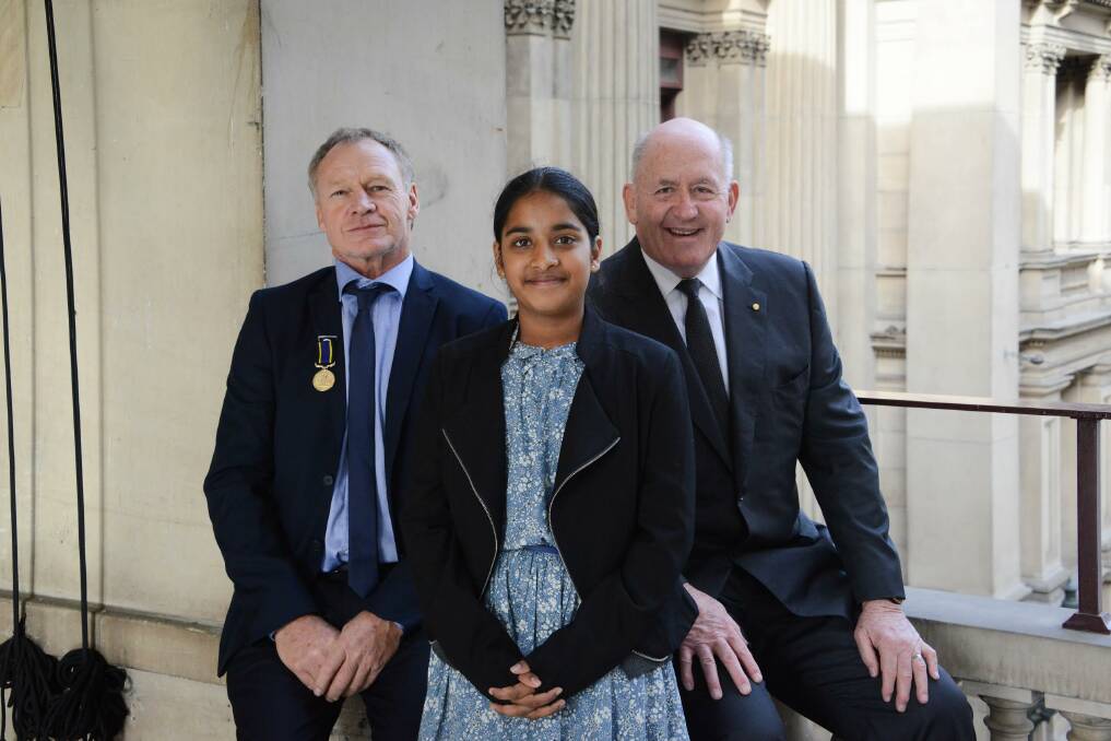 Fearless rescue: Murray Barnewall, Melanie Fonseka, now aged 12, and Governor-General Peter Cosgrove at the ceremony in Melbourne to recognise the courageous act. Photo: Fiona Basile