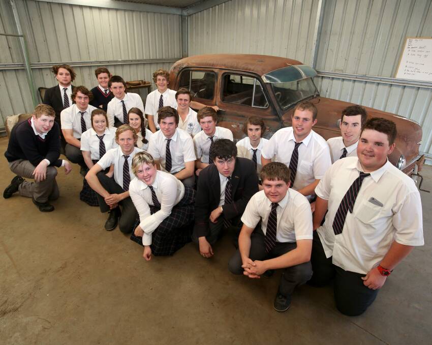 Before: The Year 12 VCAL students from Emmanuel College in April at the beginning of the project to revamp the 1953 Hillman Minx. Picture: Amy Paton