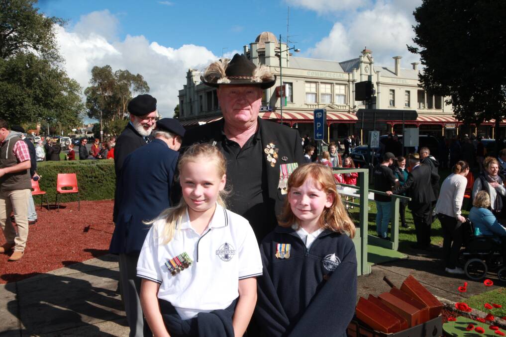 Ron Billing, who served in Vietnam, with granddaughters Eagan Winsall, 11, and Perrie Winsall, 10 at Camperdown's ANZAC Day service.