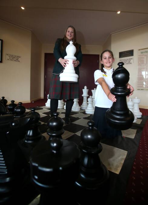 Check mate: Greta Hoy from Our Lady Help of Christians and (back) Danielle McKenzie-Sturgess from Brauer College at the chess tournament. Picture: Amy Paton