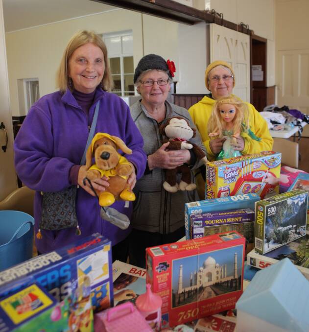 A good cause: Anglican Women's Guild secretary Marilyn Woodward, president Jenny Gent and treasurer Sue Henry at Saturday's garage sale fundraiser, where they were hoping to raise close to $1000. Picture: Sian Johnson