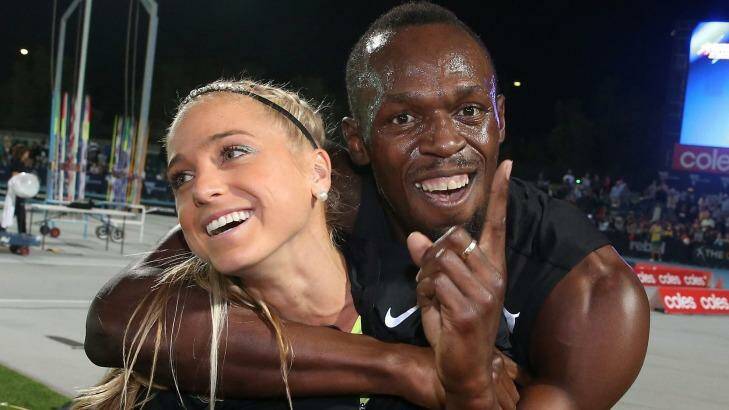 Usain Bolt hugs Australian Genevieve LaCaze as he celebrates winning the event during the Melbourne Nitro Athletics Series. Photo: Scott Barbour