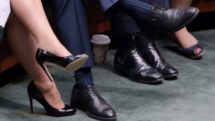 The culprit: The offending coffee cup, hidden behind Christopher Pyne's feet.  Photo: Andrew Meares