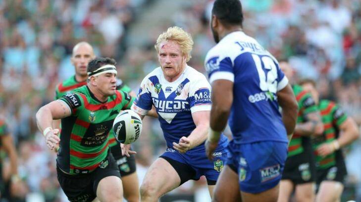Canterbury prop James Graham passes the ball wide as the South Sydney defence closes in. Photo: Anthony Johnson
