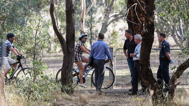 Police officers talk to other cyclists on the rail trail. Photo: Mark Jesser