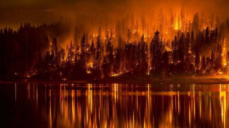 Fire approaches the shore of Bass Lake, California on Sunday. Photo: AP