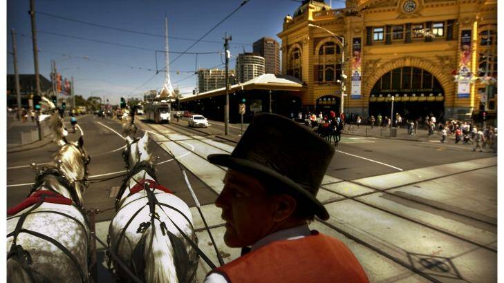 A horse drawn carriage passes one of Melbourne's best-known landmarks. Photo: Simon O'Dwyer