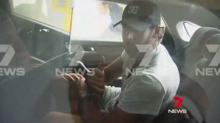 Grant Hackett is driven away by police from his parents' Gold Coast home. Photo: Courtesy of Seven News