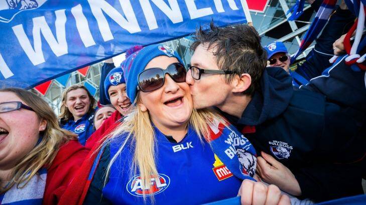 Moore gets a kiss from fellow Bulldogs supporter Chris Patmore at Whitten Oval.  Photo: Chris Hopkins