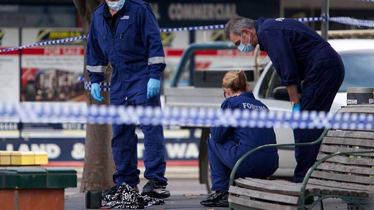 Police inspect the Sunshine shopping area where a mother of four was stabbed to death. Photo: Jason South