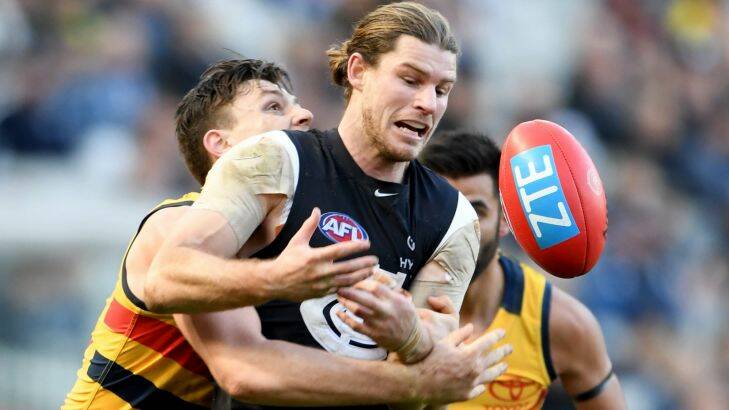 Jake Lever of the Crows tackles Bryce Gibbs of the Blues, during the round 15 AFL match between the Carlton Blues and Adelaide Crows, at the MCG in Melbourne, Saturday, July 1, 2017. (AAP Image/Joe Castro) NO ARCHIVING